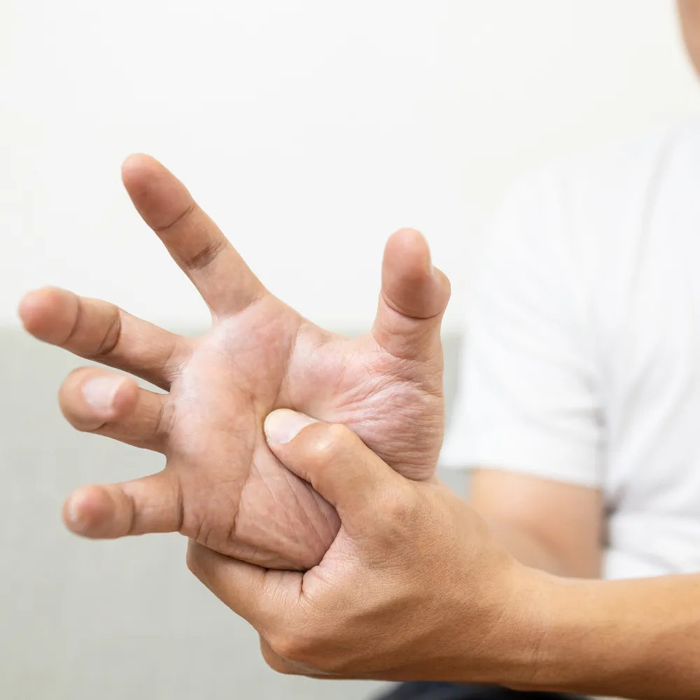 Person holding wrist in pain  