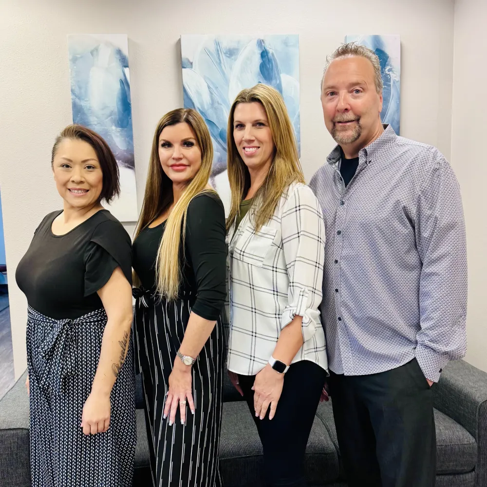 Chiropractic clinic staff team standing together and smiling