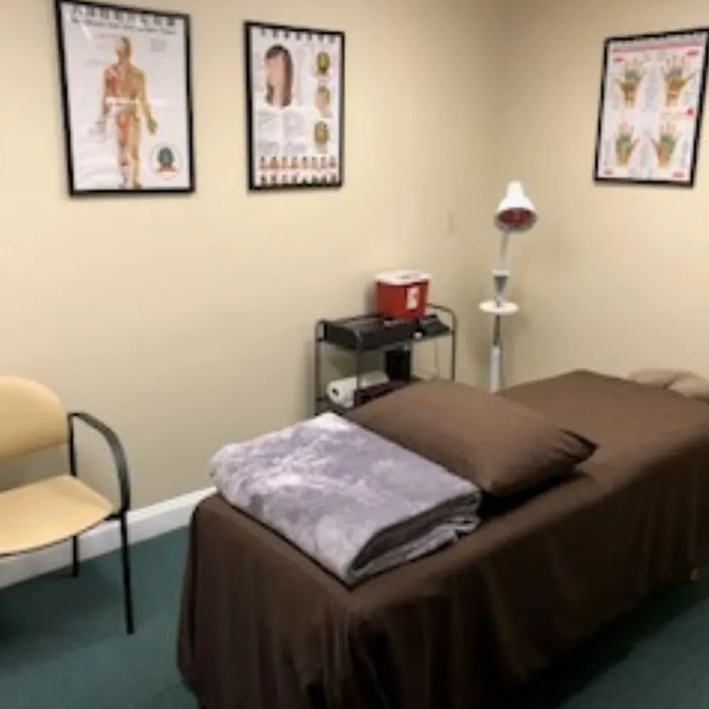 Massage therapy room with brown treatment table