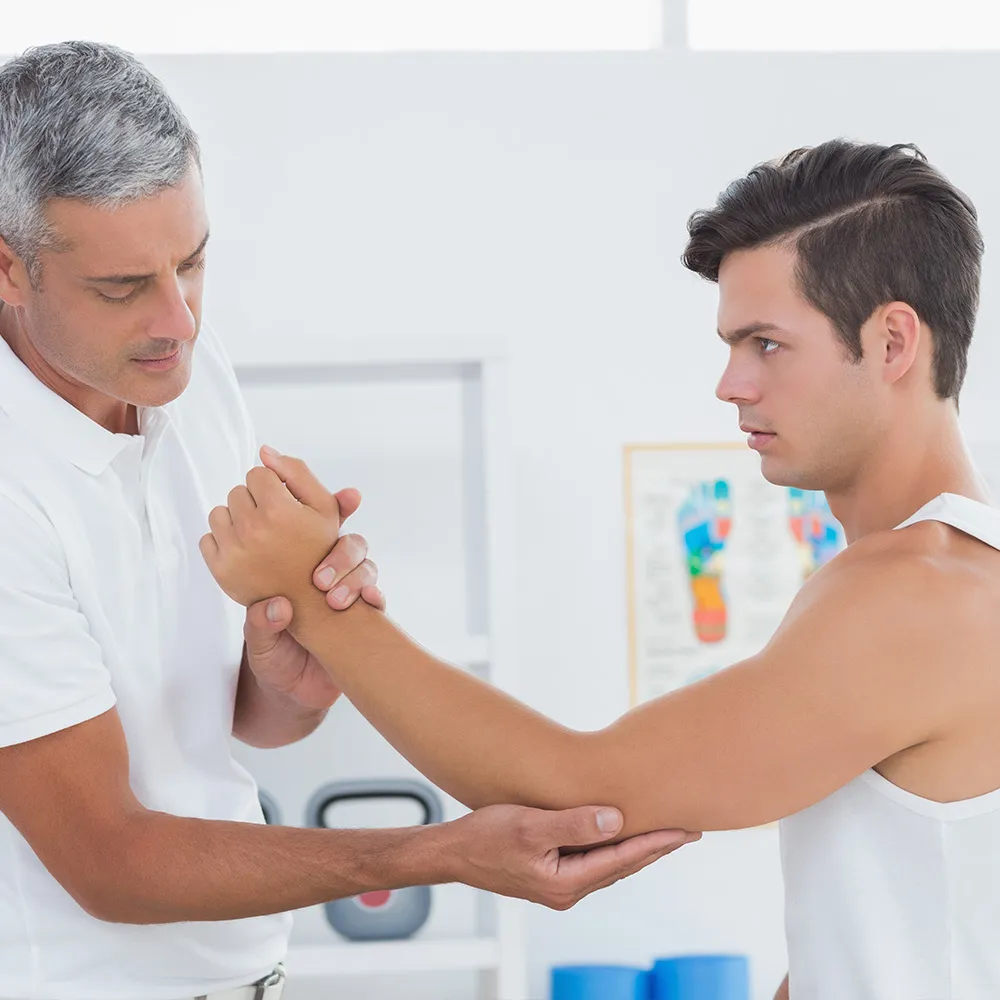Therapist assessing patient’s physical condition