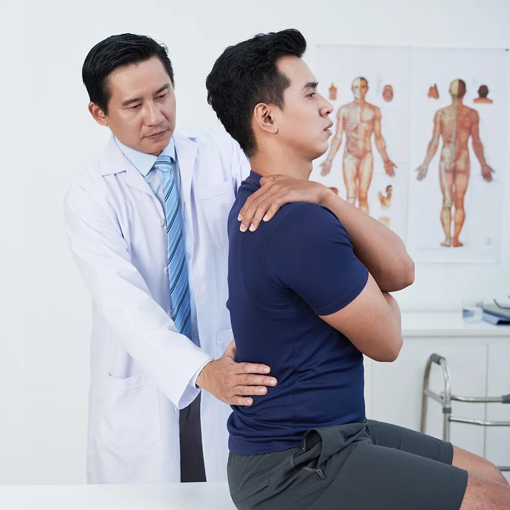 Chiropractor treating a senior man for back pain.