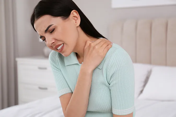 Woman holding neck, showing signs of tension