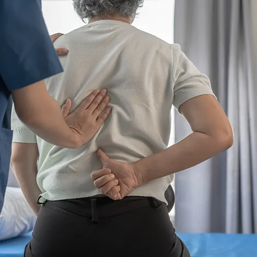 Chiropractor examining patient’s back.