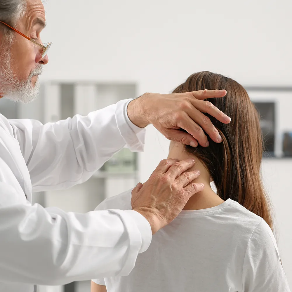 Doctor checking neck pain