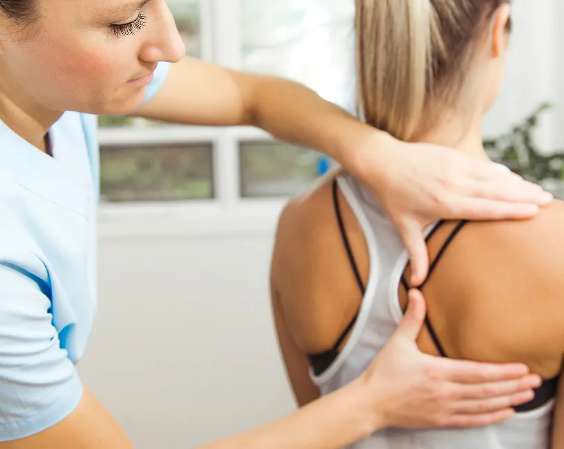 Chiropractor adjusting patient’s back  