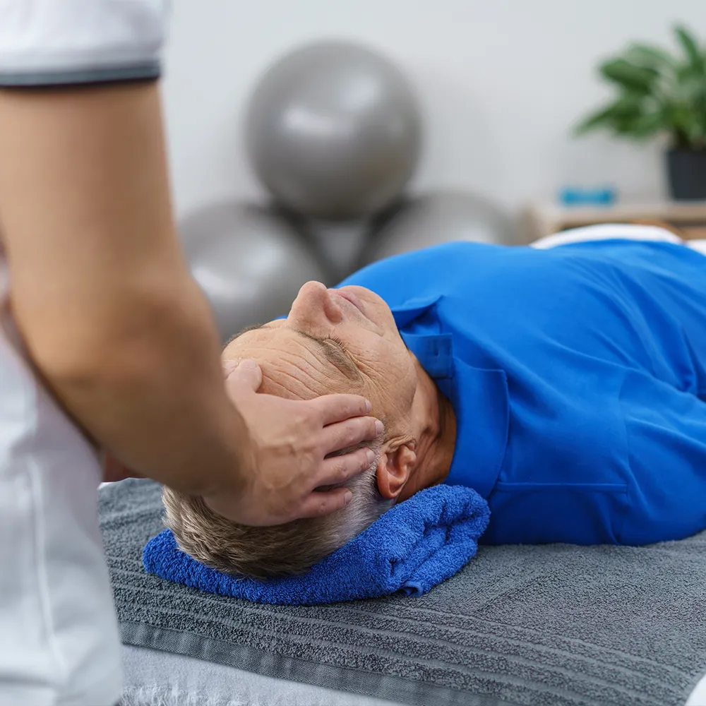 Chiropractor treating a patient's headache and migraine.