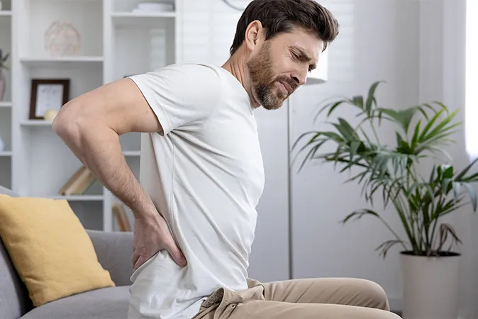 Man with back pain from poor posture  
