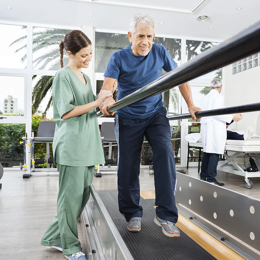 Man practicing assisted walking therapy