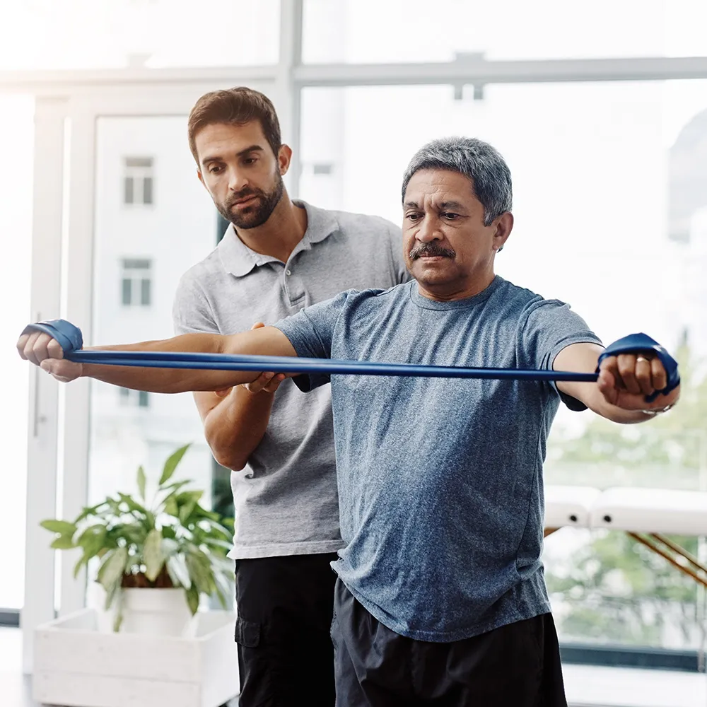 Adult male guided through physical therapy session