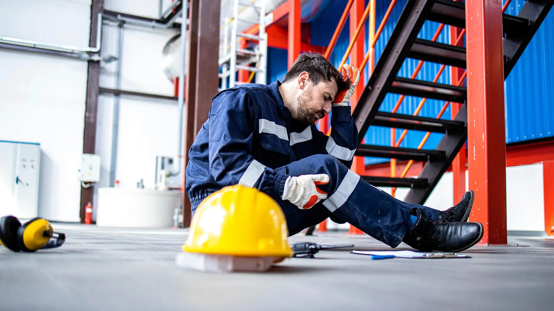 Worker holding head after workplace accident.