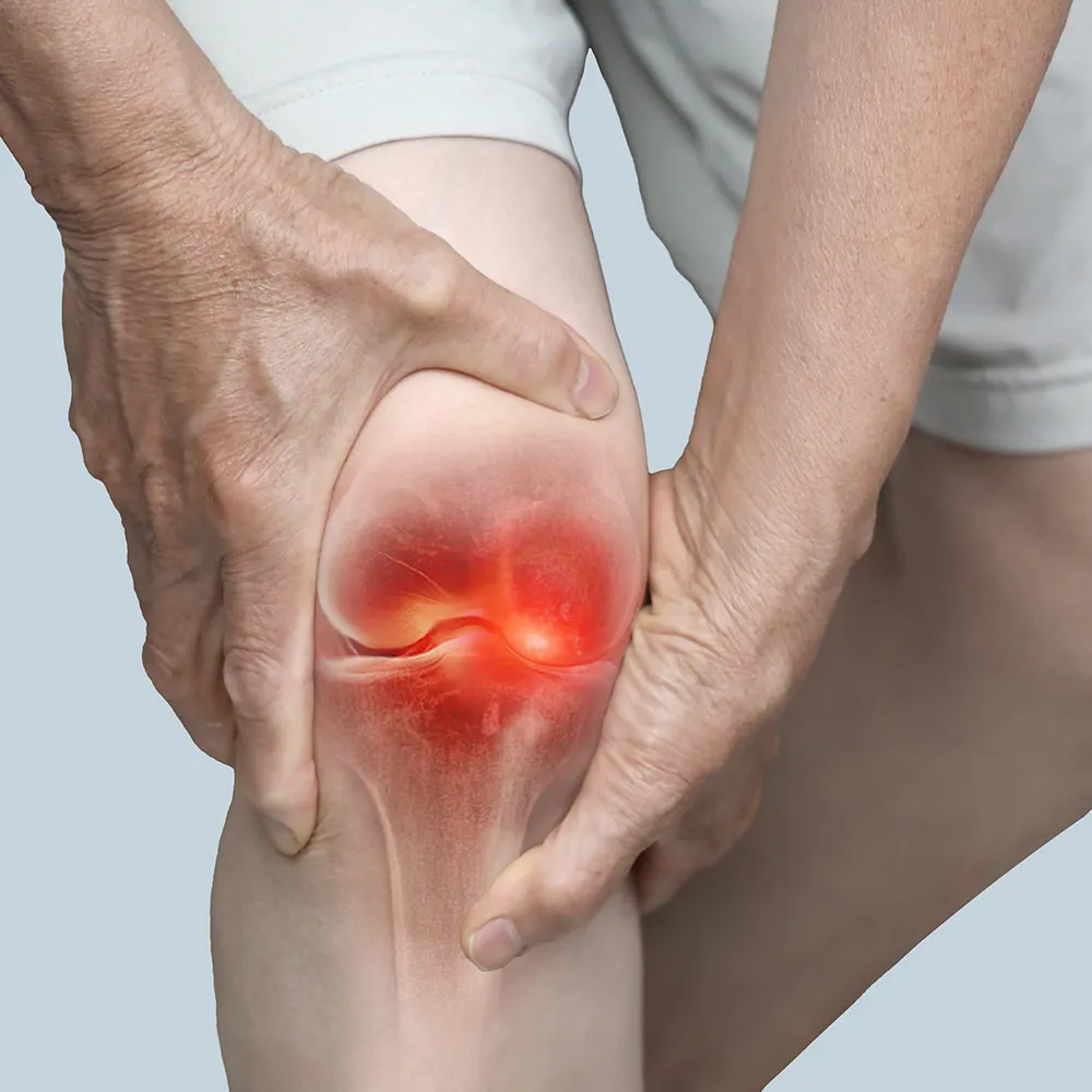 Close-up of hands on a painful knee.
