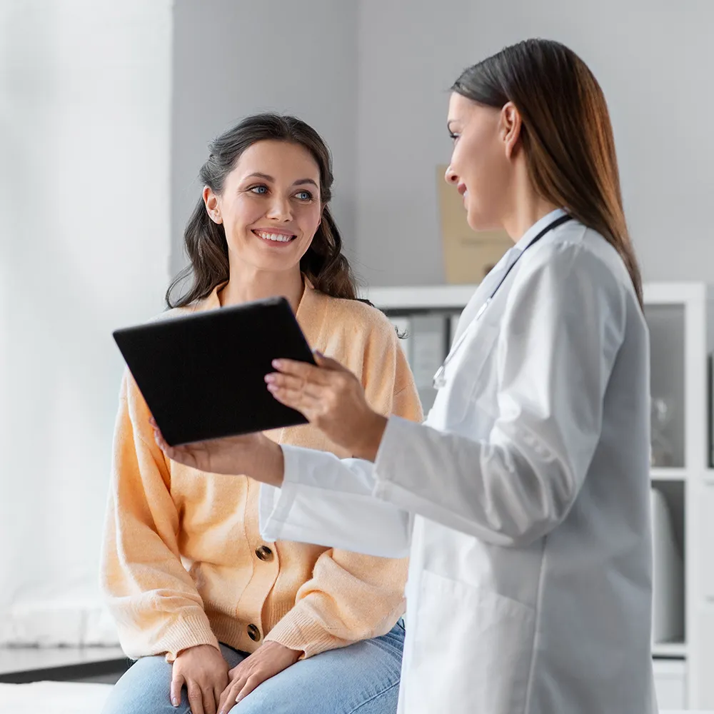 Doctor showing tablet to patient  