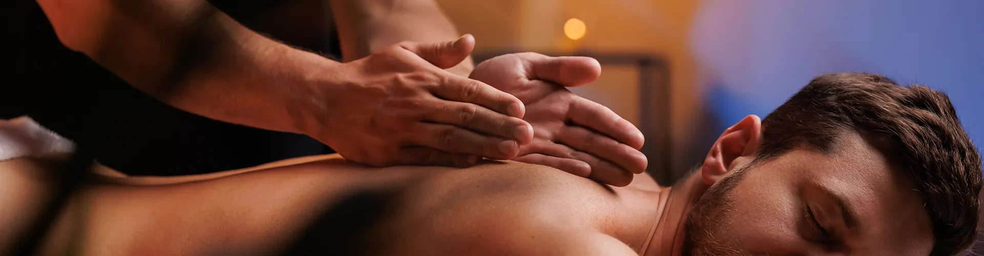 Man lying down receiving a back massage.