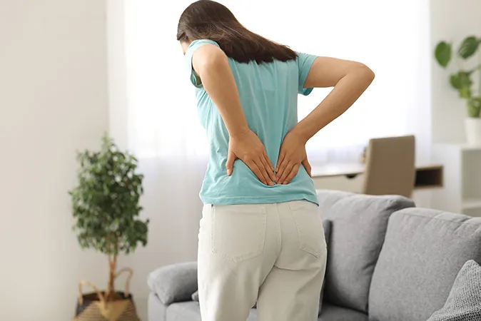 Woman holding hip in pain  