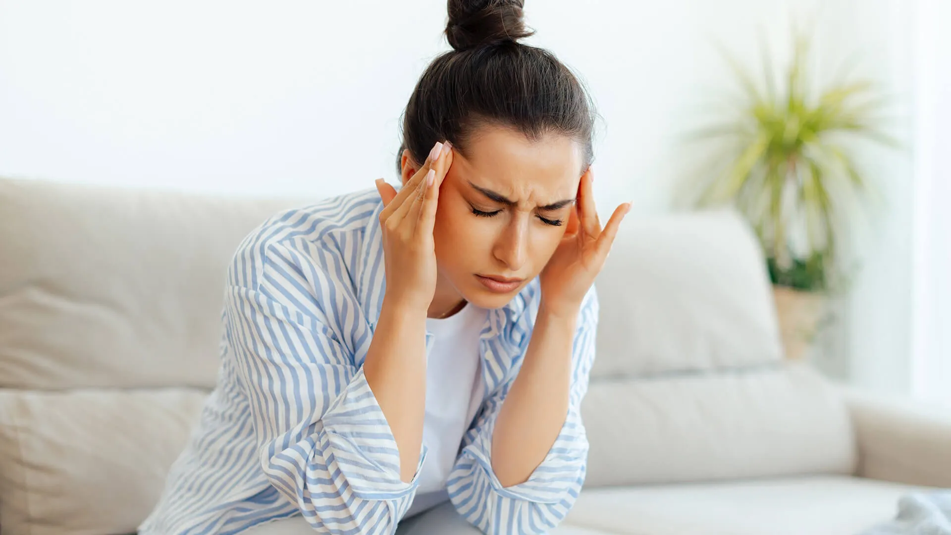 Woman with a severe headache or migraine.