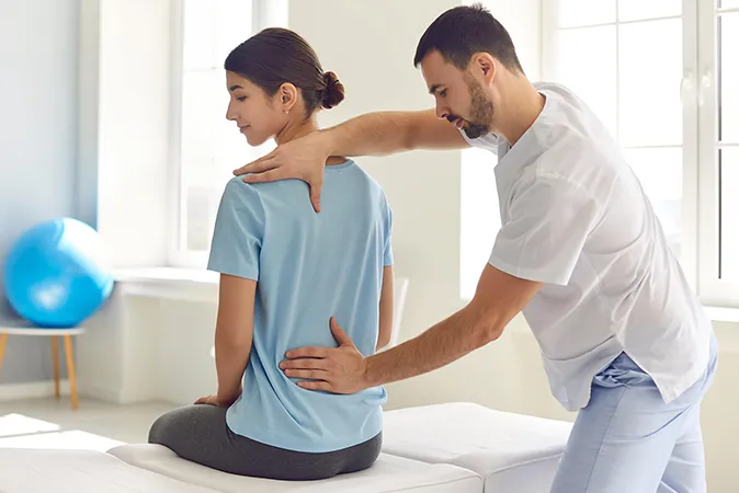 Doctor providing osteopathy treatment  
