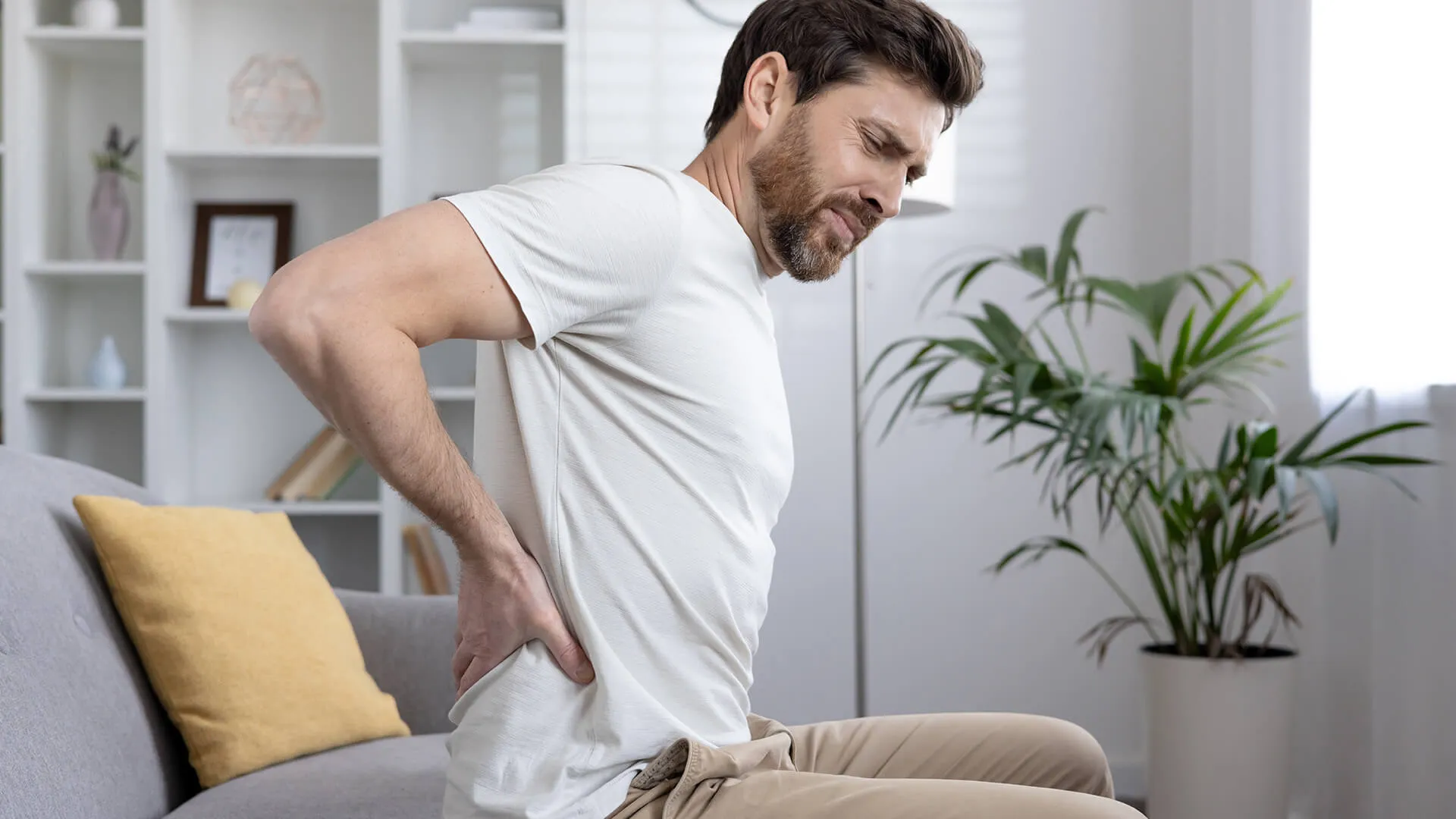 Man with back pain due to poor posture