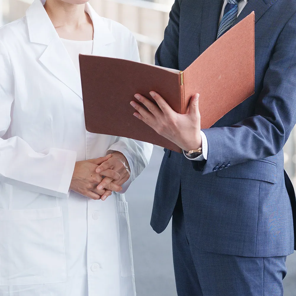 Salesperson showing strategy to doctor
