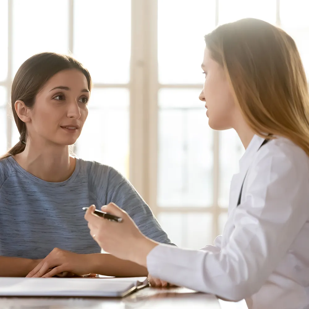 Doctor talking with patient in clinic  