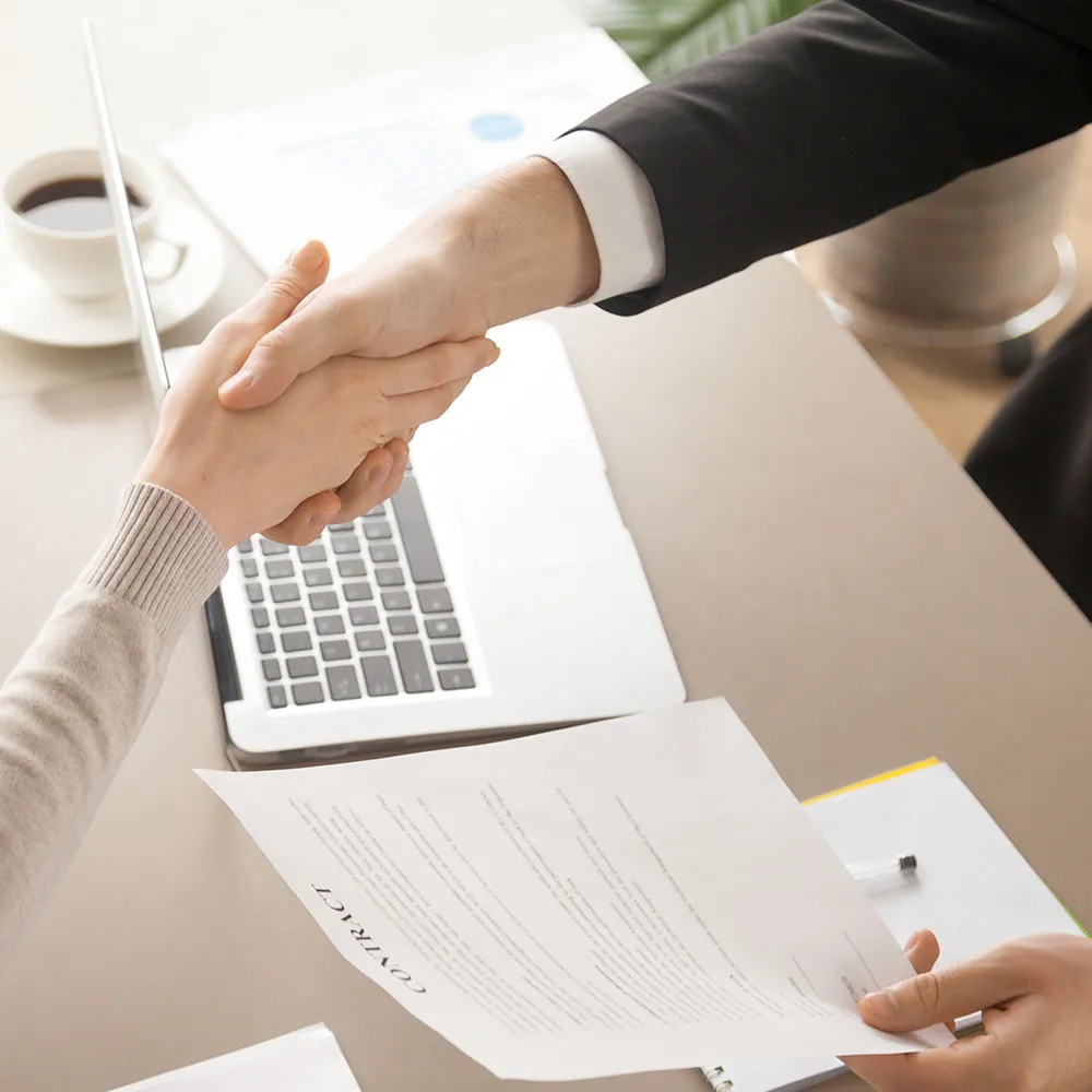 Man and woman shaking hands by contract