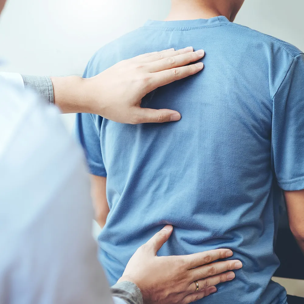 Doctor treating patient’s back pain  