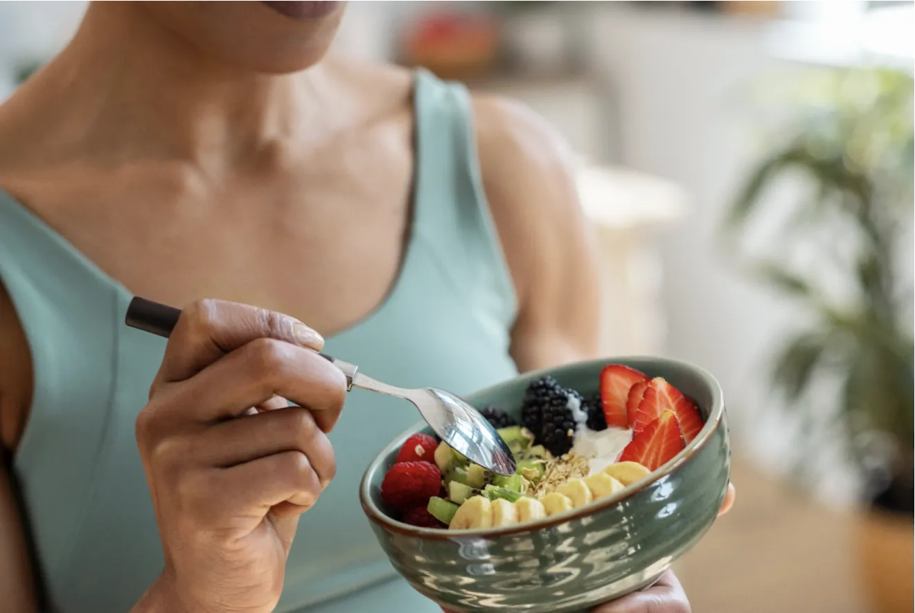 Woman eating fruit plate