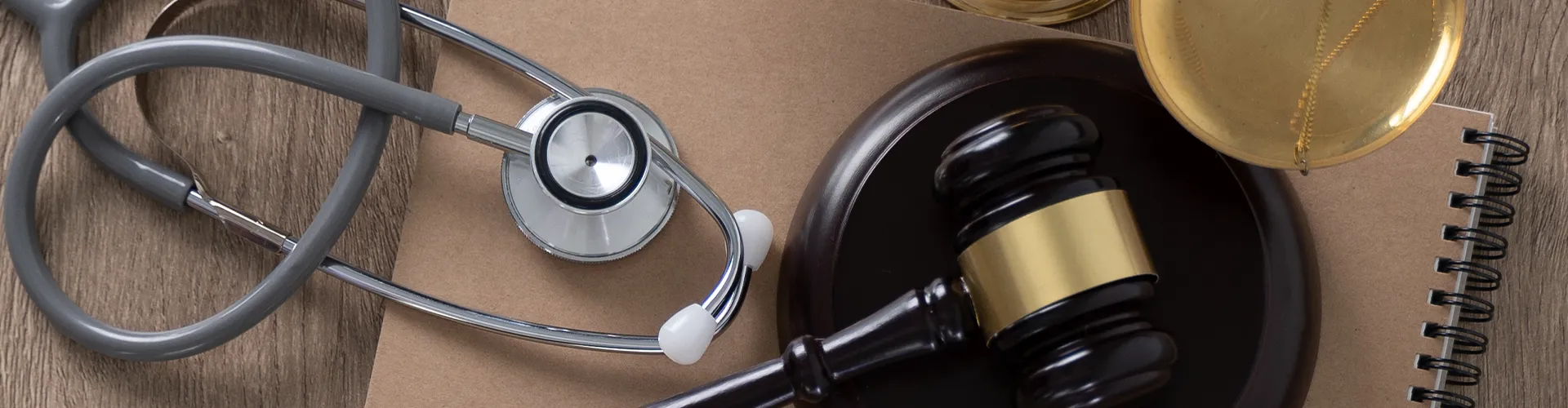 Stethoscope placed beside a judge’s gavel.