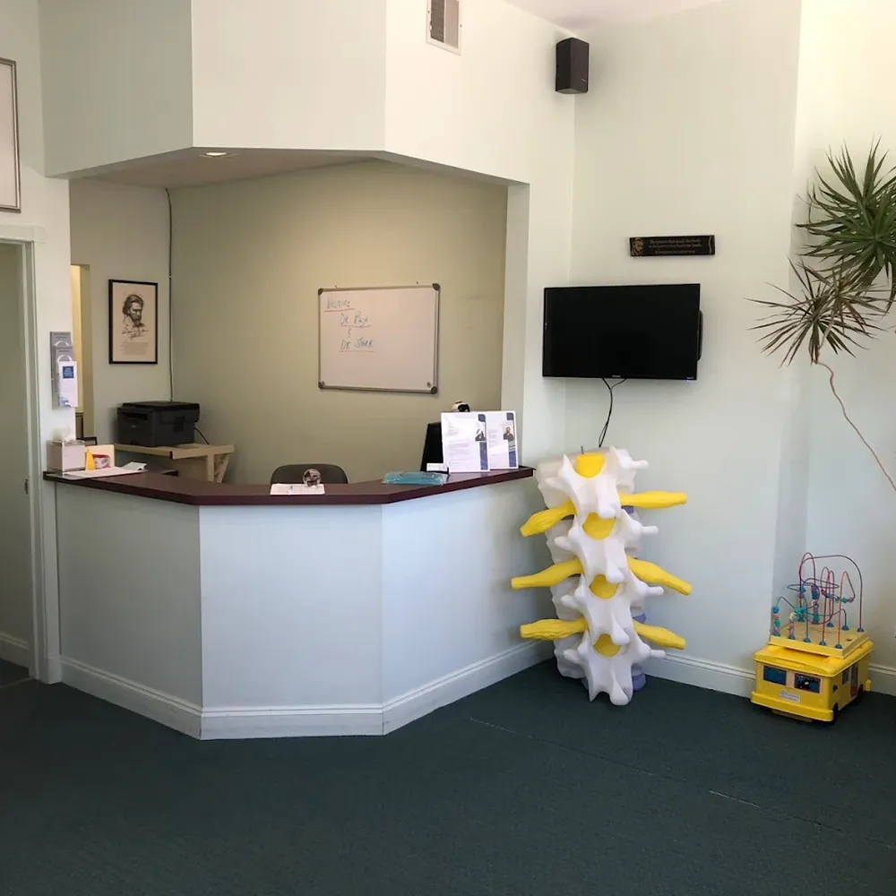 Reception desk with large spine model and TV