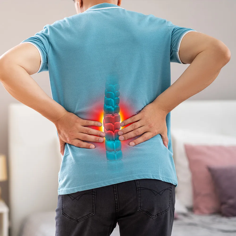 Man experiencing back pain from herniated disc injuries.