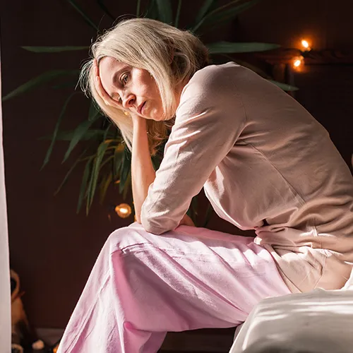Tired woman holding her face with one hand.