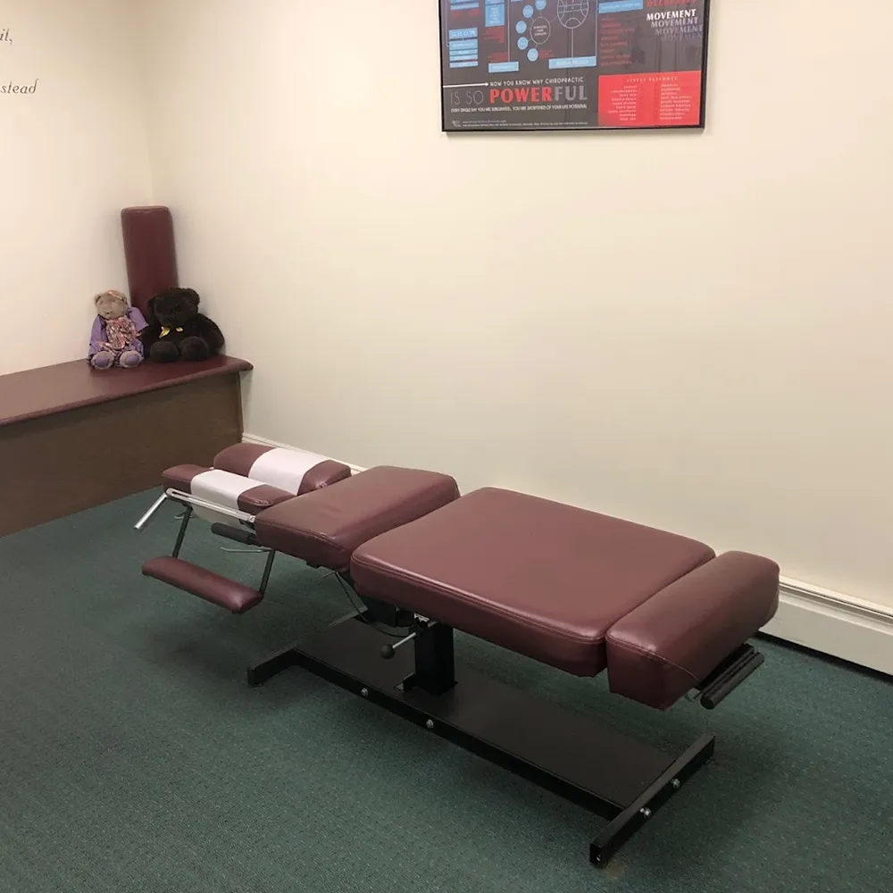 Chiropractic treatment room with red adjustment table