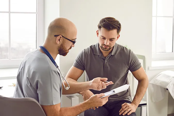 Doctor speaking and showing patient diagnosis