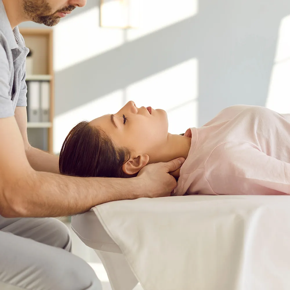 Chiropractor applying spinal adjustment  