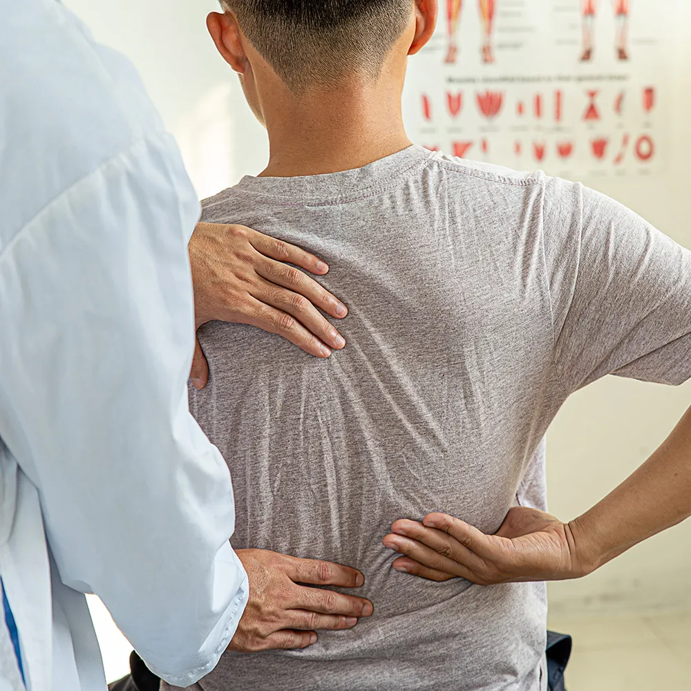 A doctor consulting a patient about back pain.