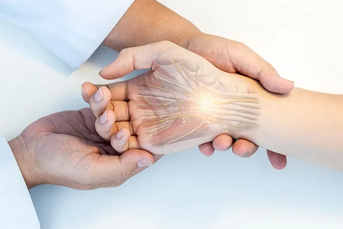 Doctor holding patient’s hand with nerve pain  