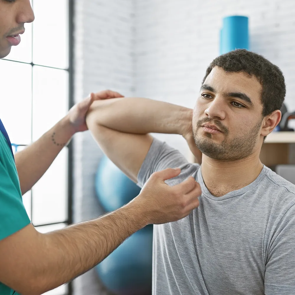 Doctor evaluating patient's shoulder