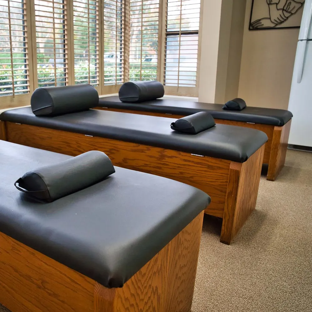 Black chiropractic adjustment tables in clinic