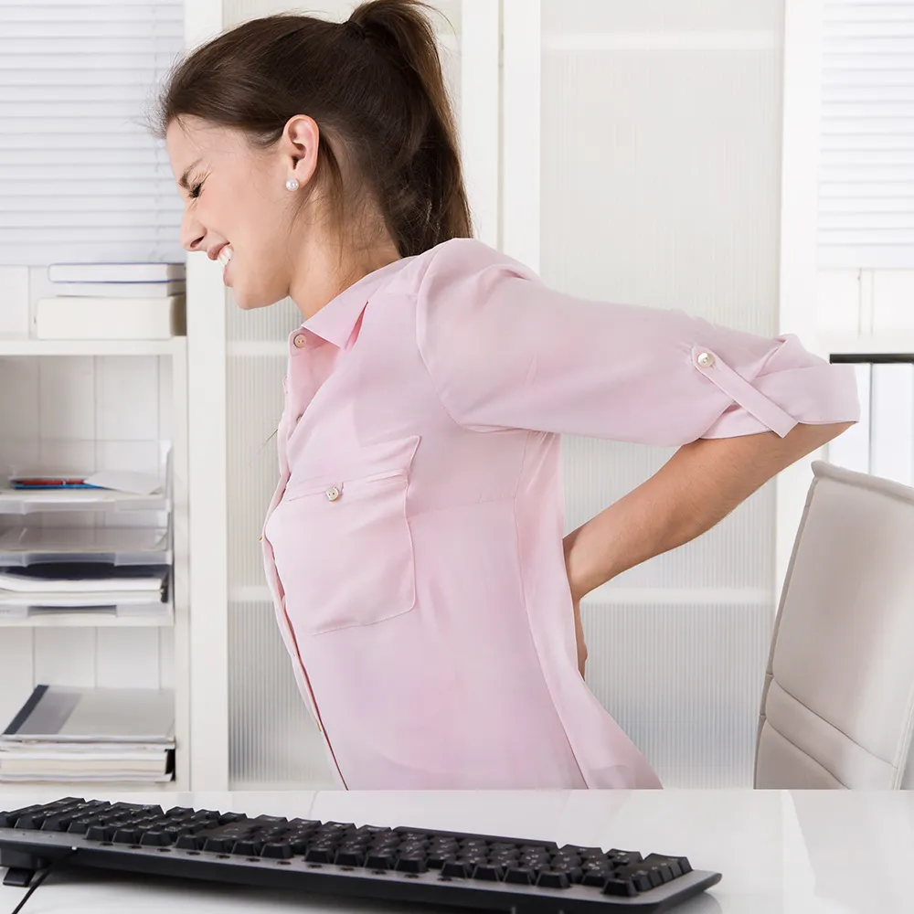 Woman holding lower back in pain