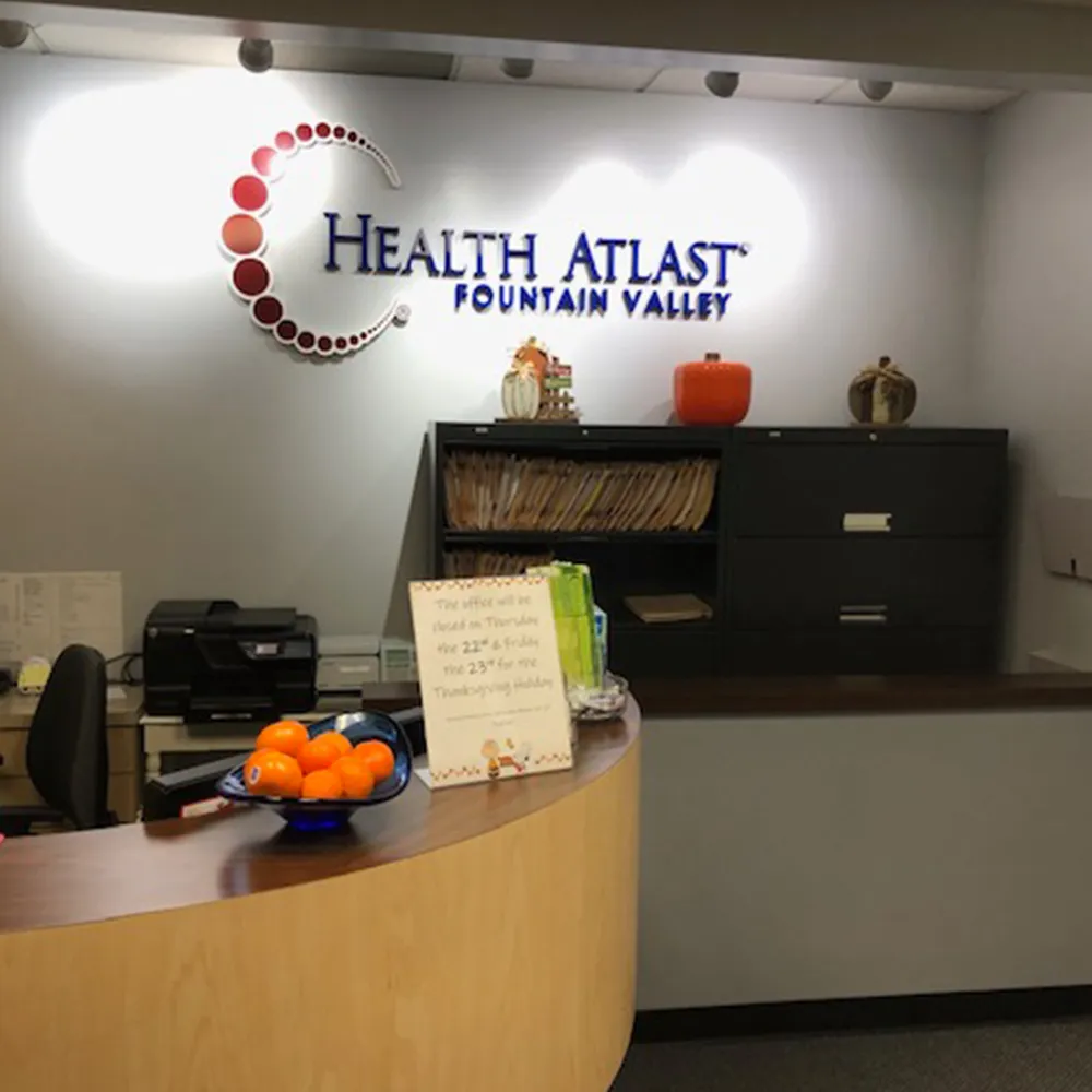 Chiropractic clinic reception desk with logo.