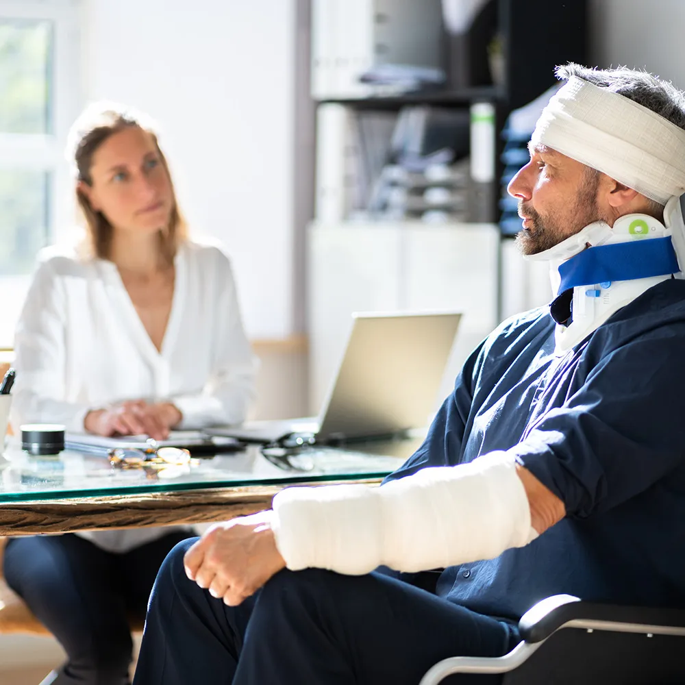 Man with bandages consulting professional.