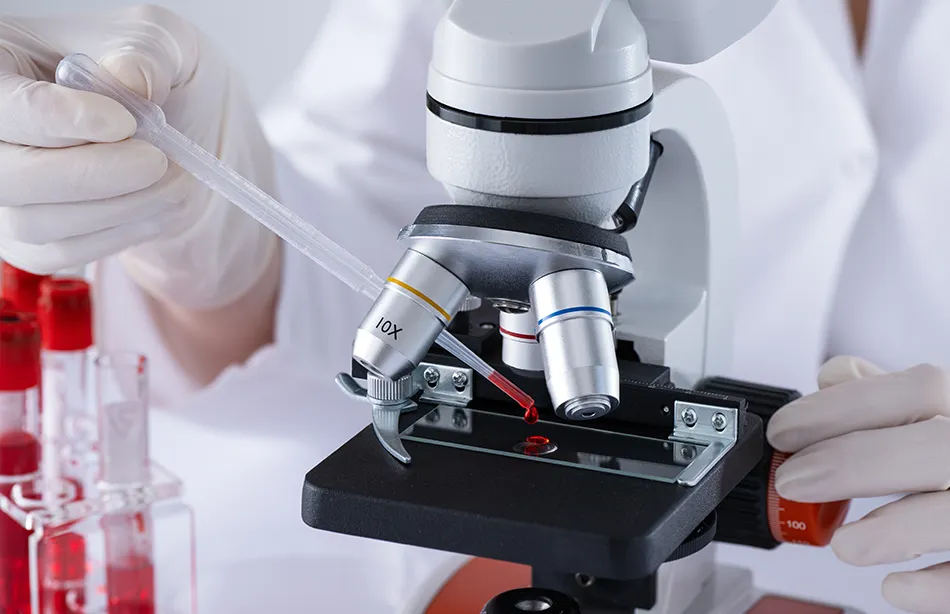  A lab technician preparing a sample on a microscope slide.