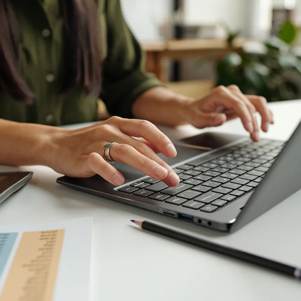  Hands typing on a keyboard, cause of carpal tunnel.