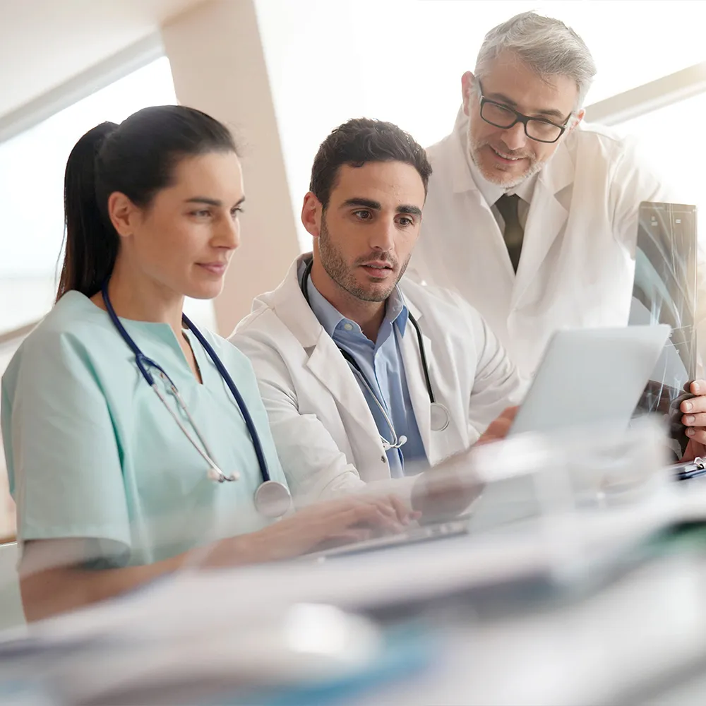 Group of doctors viewing results on a computer