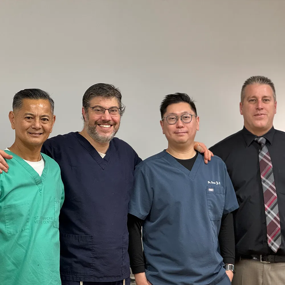 Chiropractic clinic staff team standing together and smiling