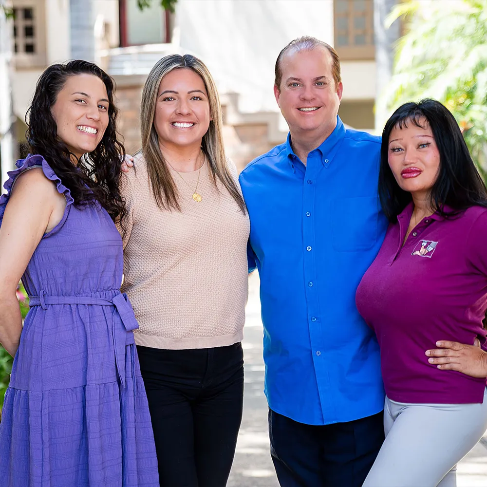 Chiropractic staff smiling outdoors together