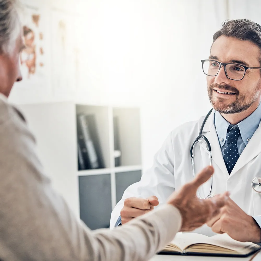 Doctor talking with patient in clinic  