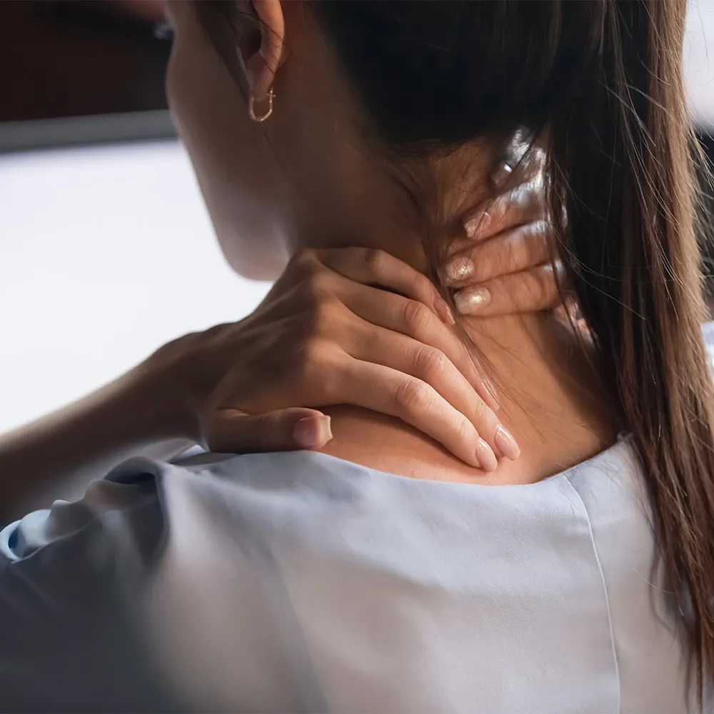 Closeup of woman massaging sore neck
