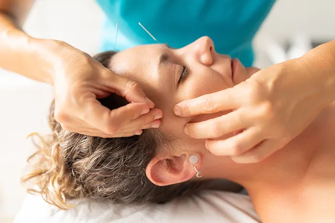 Doctor performing therapy on patient's knee