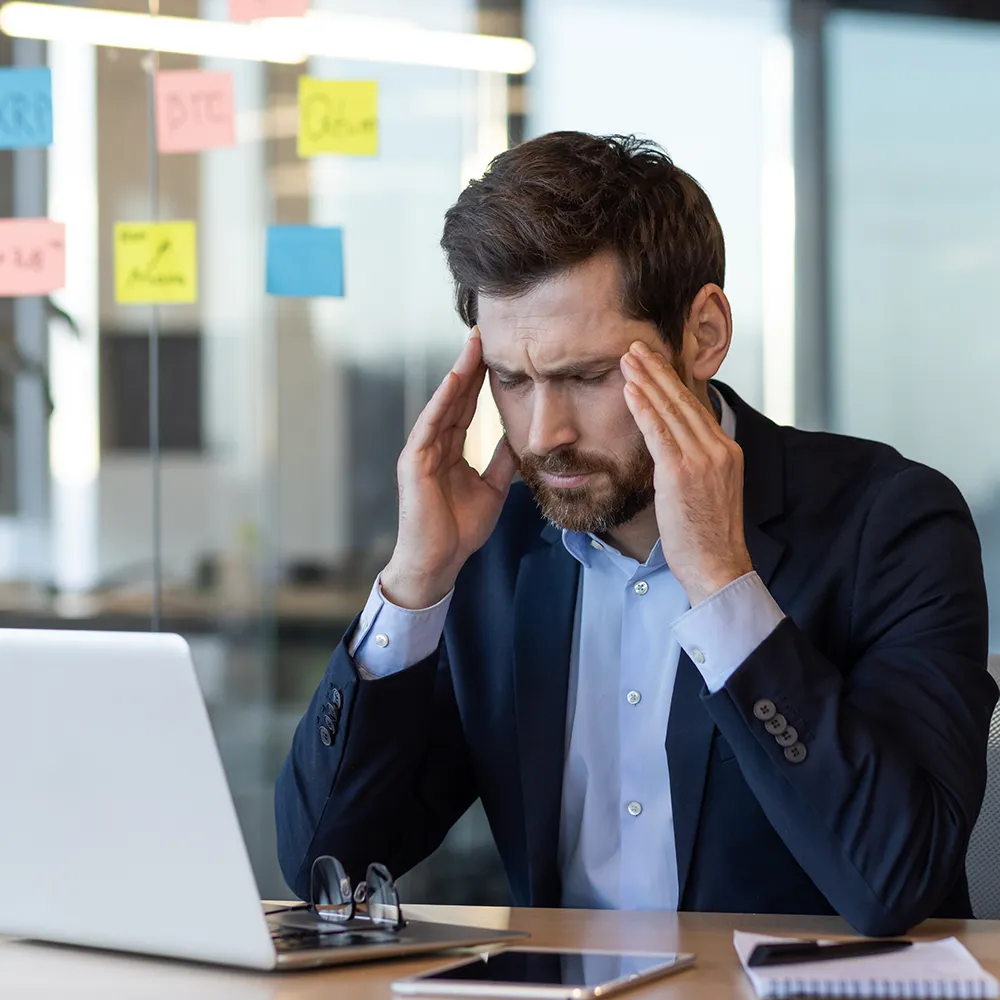 Man experiencing a headache or migraine.