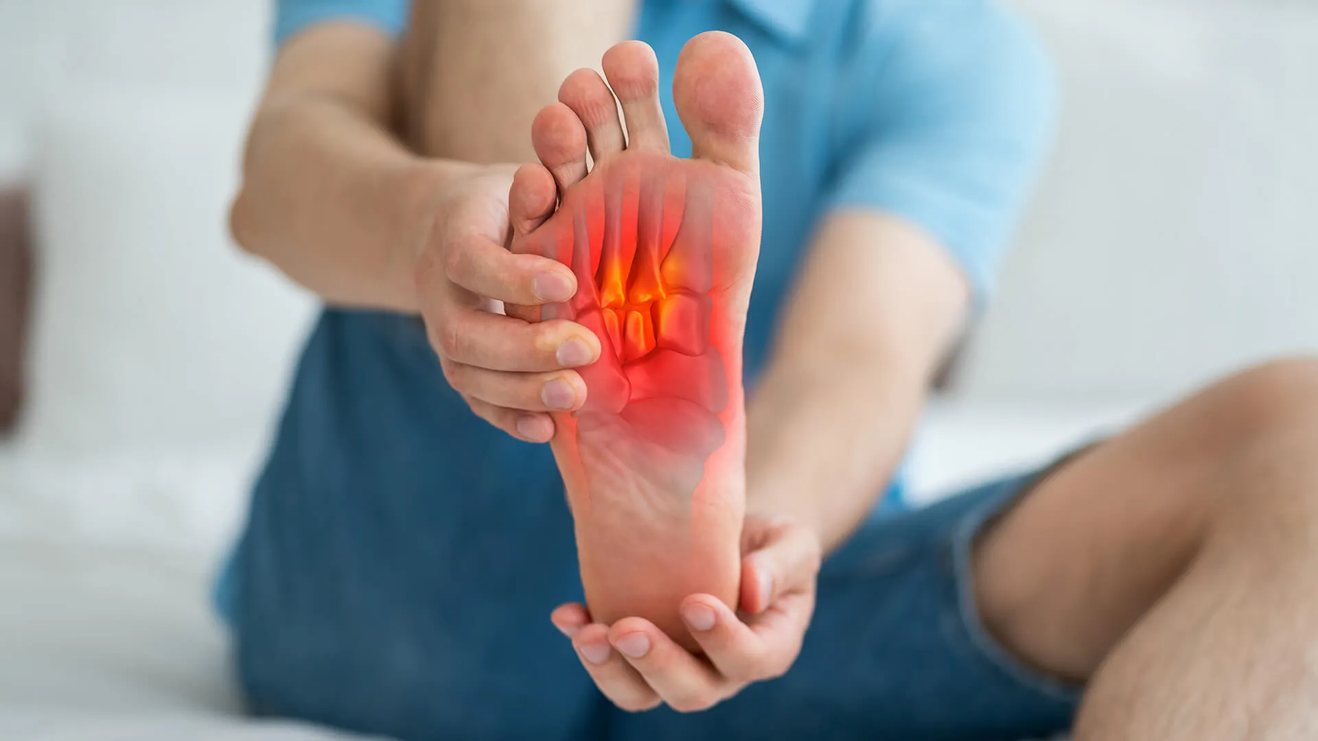 Man grabbing his foot because of pain in the sole of his foot
